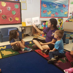 instructor reading to children